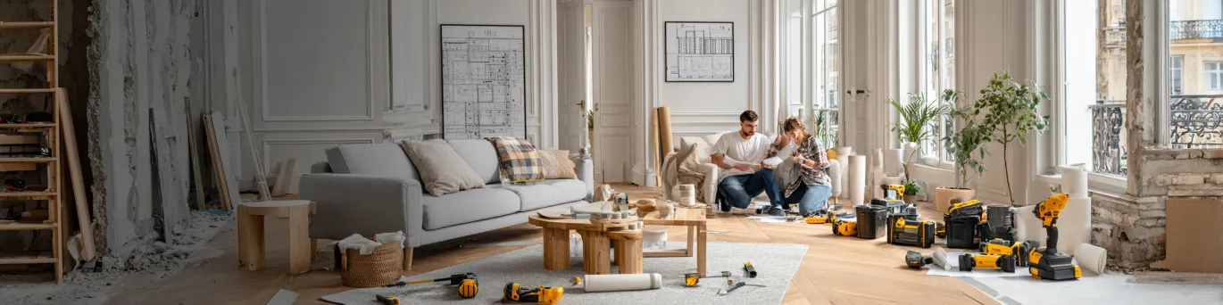 Calculatrice et plans de rénovation avec budget détaillé sur table de chantier